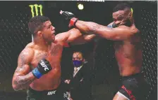  ?? GETTY IMAGES ?? Gilbert Burns, left, is now in the UFC welterweig­ht title picture after Saturday’s five-round decision over Tyron Woodley in Las Vegas.