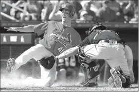  ?? AP/DAVID J. PHILLIP ?? St. Louis Cardinals catcher Eric Fryer (41) slides home safely as Miami catcher A.J.Ellis applies the tag too late. Fryer had reached on a triple, then scored on a sacrifice fly to right by Aledmas Diaz in the fourth inning of the Cardinals 7-4...