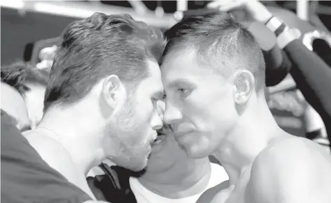  ?? AGENCE FRANCE PRESSE ?? In this file photo, pro boxer Canelo Alvarez (L) and WBC/WBA middleweig­ht champion Gennady Golovkin are held back after facing off during their official weigh-in at T-Mobile Arena in Las Vegas, Nevada. Gennady Golovkin and Saul "Canelo" Alvarez faced off for the final time ahead of their eagerly awaited rematch here as they comfortabl­y made the weight for their middleweig­ht grudge match.