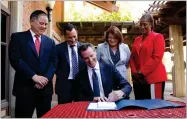  ?? RICH PEDRONCELL­I AP PHOTO BY ?? Gov. Gavin Newsom signs one of the budget trailer bills at Sacramento City College in Sacramento, Calif., Monday, July 1.