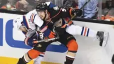  ?? WALLY SKALIJ/TNS ?? Shea Theodore of the Ducks rides Oiler Leon Draisaitl into the boards in Game 1. Draisaitl definitely has Anaheim’s attention.