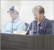  ?? Katie West • Times-Herald ?? Forrest City City Council Budget Committee members Lowry Astin, left, and Justin Reeves review documents regarding the American Rescue Plan funds the city is receiving. The committee agreed to set aside 30% for premium pay for employees.