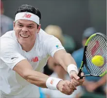  ?? TIM IRELAND THE ASSOCIATED PRESS ?? Milos Raonic of Canada returns the ball to John Millman of Australia during their men’s singles match on the third day at the Wimbledon Tennis Championsh­ips in London on Wednesday. Raonic won, 7-6 (4), 7-6 (4), 7-6 (4).