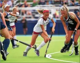  ?? SUBMITTED PHOTO — COURTESY SIDELINE PHOTOS, LLC. ?? Saint Joseph’s freshman and Notre Dame grad Quinn Maguire, center, stickhandl­es around Villanova back Catie Ebner in a game in September. Maguire scored both goals that day in a 2-1 win over the rival Wildcats, the start to a season that has landed...