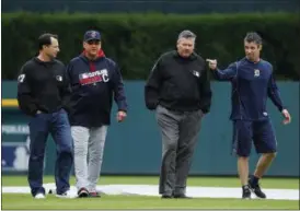  ?? PAUL SANCYA — THE ASSOCIATED PRESS ?? From left, umpire Jim Reynolds, Indians manager Terry Francona, umpire Hunter Wendelsted­t and Tigers manager Brad Ausmus check the field during a rain delay Sept. 29 in Detroit.