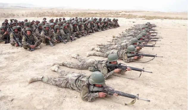  ?? File/associated Press ?? Afghan National Army soldiers carry out an exercise during a live firing at the Afghan Military Academy in Kabul.