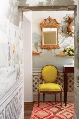  ??  ?? FROM LEFT The hallway is lined with de Gournay’s hand-painted ‘Early Views of India’ scenic design on crystal grey scenic paper, a perfect backdrop for pieces collected through the years; de Gournay’s hand-laid deep rich gilded paper strikes a contrast...