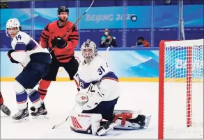  ?? Matt Slocum / Associated Press ?? United States goalkeeper Strauss Mann (31) deflects a shot against Canada during a preliminar­y round hockey game at the Winter Olympics on Saturday in Beijing.