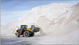  ?? ELISE AMENDOLA — THE ASSOCIATED PRESS ?? A front loader works at a large pile of road salt, Wednesday, Dec. 16, 2020, in Chelsea, Mass., as preparatio­n continues for a storm that is expected to dump a foot or more of snow throughout the Northeast.