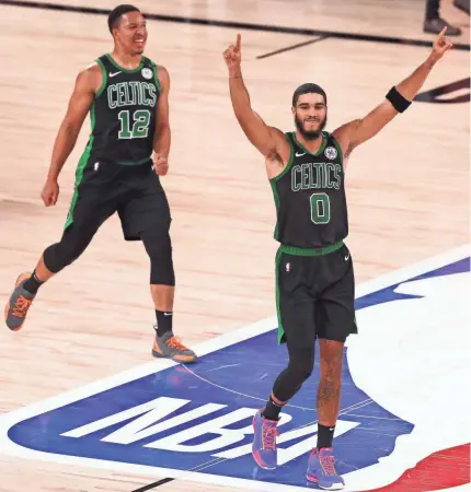  ?? KIM KLEMENT/USA TODAY SPORTS ?? Jayson Tatum (0) celebrates with Grant Williams (12) after the Celtics defeated the NBA defending champion Raptors in the Eastern Conference series.