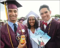  ??  ?? LEFT: Woonsocket graduates, from left, Neftalie Ortiz, Ashaiya Feliz, and Kaleb Rodas reflect on Kaleb’s mortarboar­d ‘Bless Up,’ his inspiratio­nal message to the Class of 2017, while getting ready for Woonsocket High School’s graduation.