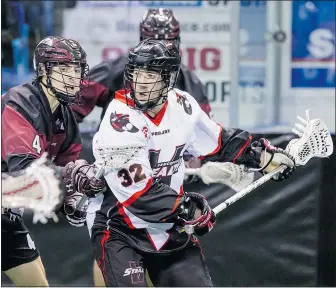  ??  ?? Vancouver Stealth southpaw Mitch McMichael holds off Colorado Mammoth defence man Josh Sullivan — who plays his summer box lacrosse for the Coquitlam Adanacs — during Saturday night’s game at the LEC.
— GARRETT JAMES