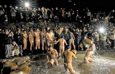  ?? ?? WASHING AWAY EVIL Men cleanse their bodies in a river during the Sominsai ritual, widely regarded as one of the strangest festivals in Japan which regularly draws thousands of tourists.