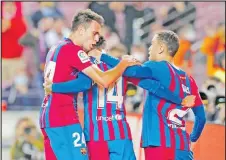  ?? Picture: REUTERS ?? FC Barcelona’s Philippe Coutinho, left, celebrates scoring their third goal with Eric Garcia, 14, and Sergino Dest.