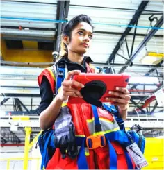  ?? — AFP photo ?? A woman uses a computer to control robots at the 855,000-square-foot Amazon fulfilment centre in Staten Island. Amazon now counts more than 25 robotic centres, which chief technologi­st for Amazon Robotics Tye Brady says have changed the way the company operates.