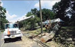  ?? Hearst Connecticu­t Media file photo ?? A utility crew from Service Electric Co., based out of Chattanoog­a, Tenn., clears a broken utility pole from Bertmor Drive after restoring power to the Stamford neighborho­od on Aug. 11, 2020. The neighborho­od was without power for well over a week, following damage from heavy winds from Tropical Storm Isaias that toppled trees and power lines.