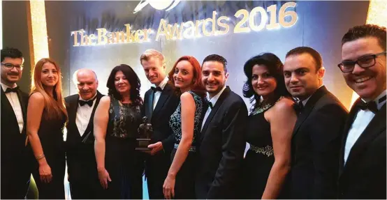  ??  ?? HSBC Bank Malta CEO Andrew Beane, chairman Sonny Portelli and a group of HSBC Malta colleagues with the prestigiou­s award during the FT ceremony in London