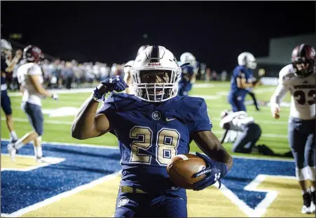  ?? NWA Democrat-Gazette/CHARLIE KAIJO ?? Bentonvill­e West High School Tyrese Smallwood (center) reacts Friday after a score against Springdale High at Wolverine Stadium in Centerton.