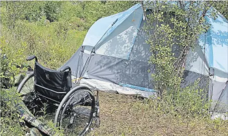  ?? LISA RUTLEDGE CAMBRIDGE TIMES ?? A wheelchair sits outside a tent pitched just off a trail in Hespeler, where two people have been living for several weeks.