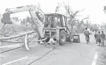  ?? — AFP photo ?? Operating a backhoe on the road in Puri. Cyclone Fani, one of the strongest to hit India in two decades, tore into Odisha on May 3, leaving a trail of devastatio­n across the coastal state of 46 million people.