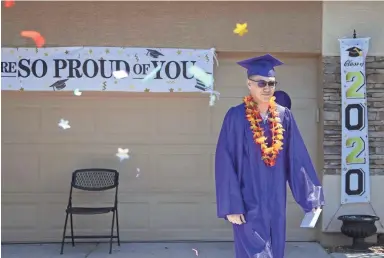  ?? PHOTOS BY CHERYL EVANS/THE REPUBLIC ?? Angel Queiro is surprised by members of his church, New Foundation Church in Goodyear, with a driveway graduation. Queiro is graduating from Hope High School.