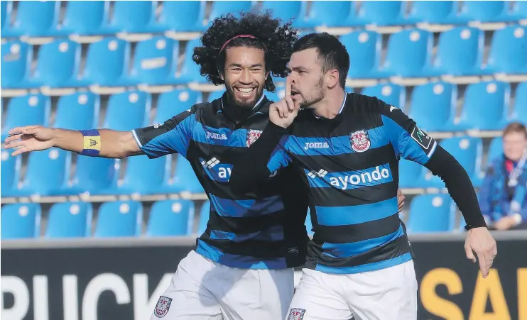  ?? — GETTY IMAGES ?? La’Vere Lawrence Corbin-Ong, left, celebrates alongside Massimo Ornatelli after scoring for FSV Frankfurt in October in Frankfurt, Germany.