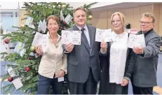  ?? FOTO: KSK ?? Heike Hildebrand­t,, KSK, Filialdire­ktor Thomas Döring sowie Bianca Schnee und Thomas Rasch, beide Caritas (v.l.) vor dem Baum.