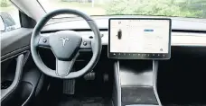  ??  ?? The Model 3’s simplistic interior in dominated by a 15-inch touch screen.