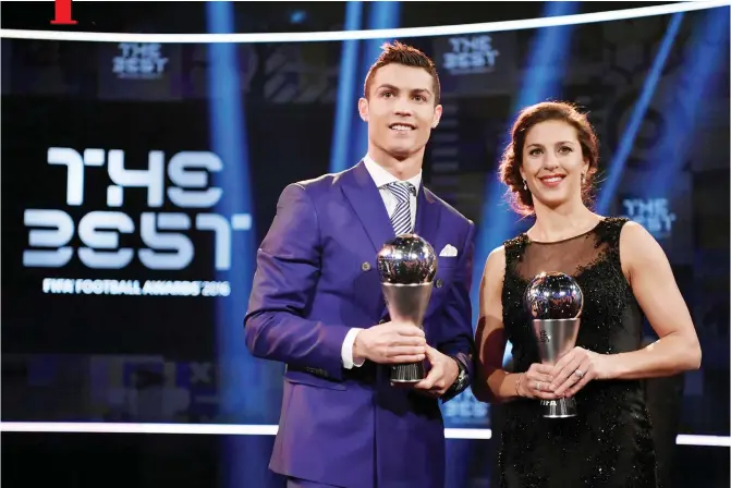 ?? — AFP ?? ZURICH: Real Madrid and Portugal’s forward and winner of The Best FIFA Men’s Player of 2016 Award Cristiano Ronaldo stands on stage with Houston Dash and US midfielder and winner of The Best FIFA Women’s Player of 2016 Carli Lloyd following The Best...