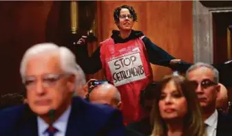  ?? AFP ?? A supporter of Palestinia­n rights disrupts the confirmati­on hearing of David Friedman as he testifies before the Senate Foreign Relations Committee in Washington on Thursday.