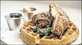  ?? CONTRIBUTE­D BY MIA YAKEL ?? Luda’s Chicken and Pecan Waffles is served with whiskey maple syrup, spinach and andouille sausage.