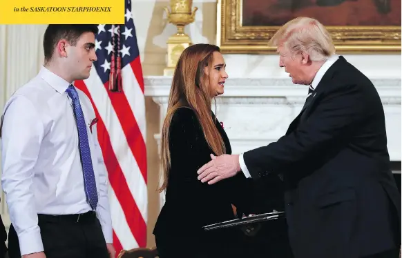  ?? CAROLYN KASTE /THE ASSOCIATED PRESS ?? U.S. President Donald Trump greets Julia Cordover, student body president at Marjory Stoneman Douglas High School in Parkland, Fla., and her schoolmate Jonathan Blank at a listening session on Wednesday at the White House with students, teachers and...