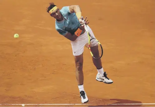 ??  ?? 0 Rafa Nadal serves to Felix Auger-aliassime during his 6-3, 6-3 win over the Canadian in the Madrid Open second round yesterday.