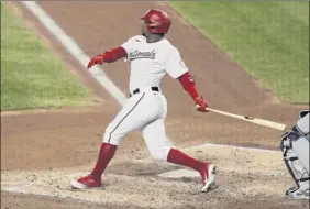  ?? Patrick Smith / Getty Images ?? Victor Robles of the Nationals tracks his two-run home run in the fourth inning Saturday. Robles had a double and a single in addition to the homer.