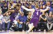  ?? GERRY BROOME AP ?? Stephen F. Austin’s Nathan Bain (23) and David Kachelries cheer Bain’s game-winner against Duke.