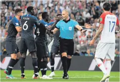  ??  ?? Controvers­y: players appeal for a penalty for handball which was eventually given and converted by Antoine Griezmann