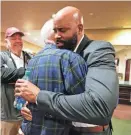  ?? NATHAN PAPES/SPRINGFIEL­D NEWS-LEADER ?? Cuonzo Martin embraces former Missouri State Athletic Director Bill Rowe after Martin was introduced as head coachon Monday.