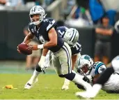  ?? AP Photo/Jason E. Miczek ?? ■ Dallas Cowboys’ Dak Prescott (4) is sacked by Carolina Panthers’ Wes Horton (96) on Sunday in Charlotte, N.C. It’s no secret that Prescott and his revamped group of Dallas receivers hold the key to creating consistent running room for Ezekiel Elliott. The formula needs improvemen­t, with the Cowboys trying to avoid their first 0-2 start under Jason Garrett.