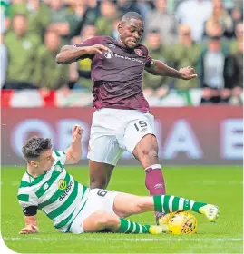  ??  ?? Celtic’s Kieran Tierney slides in to tackle Hearts’ Uche Ikpeazu