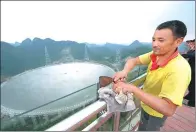  ?? ZHAO HUI / FOR CHINA DAILY ?? A worker cleans the guardrail of a sightseein­g platform near the world’s largest single-aperture telescope in Pingtang county, Guizhou province, in September.