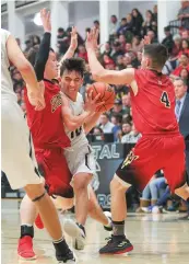  ?? GABRIELA CAMPOS/NEW MEXICAN FILE PHOTO ?? Capital’s Tyler Alarid gets smashed between Española’s defense on his way to the basket during a Feb. 9 game at Capital.