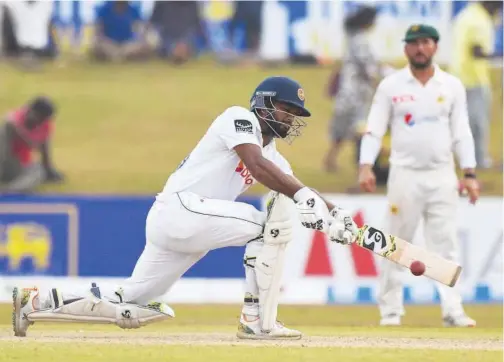  ?? Agence France-presse ?? ↑ Sri Lanka’s captain Dimuth Karunaratn­e plays a shot during the third day of the second Test against Pakistan in Galle on Tuesday.