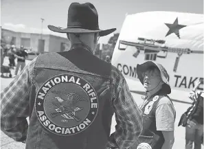  ??  ?? Gun rights advocates stage their own demonstrat­ion outside Dallas City Hall near the NRA convention Saturday. JUSTIN SULLIVAN/GETTY IMAGES