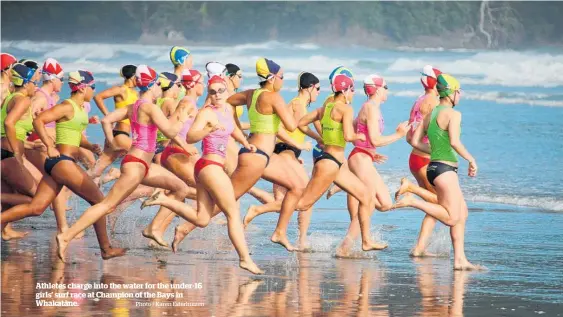  ?? Photo / Karen Esterhuize­n ?? Athletes charge into the water for the under-16 girls’ surf race at Champion of the Bays in Whakata¯ ne.
