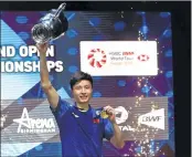  ??  ?? Shi Yuqi celebrates with the winner's trophy on the podium after beating Lin Dan in the final.