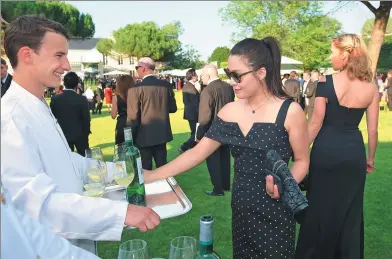  ?? NICOLAS TUCAT / AGENCE FRANCE-PRESSE ?? Guests attend the 65th Fete de la Fleur (flower party) in Leognan, France, on Wednesday, marking the end of Vinexpo, the world’s largest wine and spirits fair.