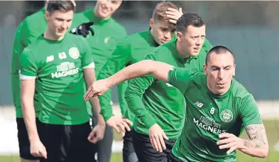  ?? Picture: SNS. ?? Celtic captain Scott Brown shows his team-mates a clean pair of heels.