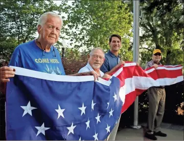  ?? Jeremy stewart ?? Brewster-Cleveland American Legion Post 86 Commander Kenneth Roberts (from left), Polk County Commission­er Gary Martin, state Rep. Trey Kelley, and Polk County Commission Chairman Hal Floyd hold the new American flag for Cedartown’s Veteran’s Memorial Park on Wednesday, July 28, 2021.