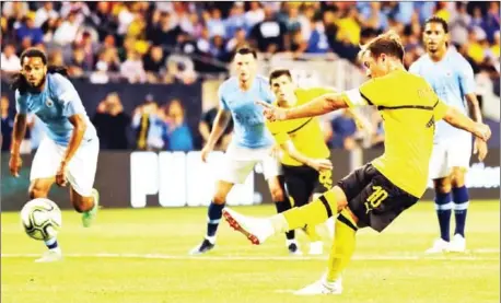  ?? AFP ?? Mario Gotze of Borussia Dortmund scores from a penalty kick against Manchester CItyin the first half of their Champions Cup match at Soldier Field on Friday in Chicago, Illinois.