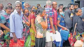  ?? AP ?? People queue up to buy kerosene oil for cooking amid shortages in Colombo on Tuesday.